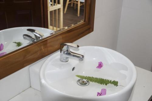 a bathroom sink with a green comb on it at HON BA LAGI BEACH RESORT in La Gi