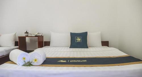 a hotel room with a bed with towels on it at HON BA LAGI BEACH RESORT in La Gi