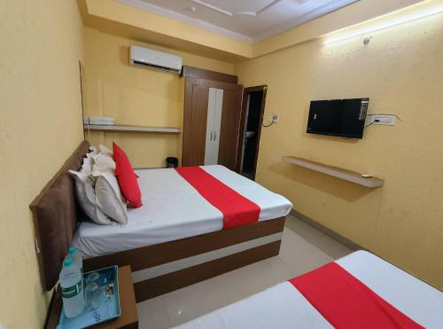a hotel room with a bed and a tv at Hotel K A Square in Bhopal