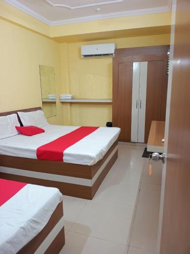a hotel room with a bed and a door at Hotel K A Square in Bhopal