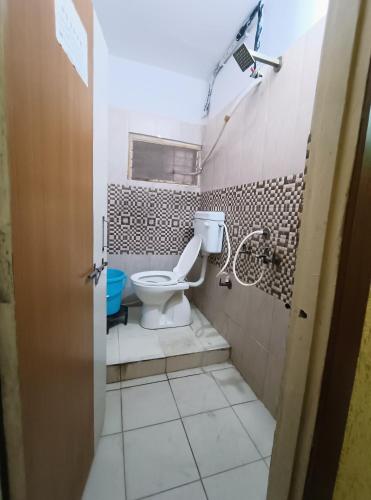 a bathroom with a toilet and a shower at Hotel K A Square in Bhopal