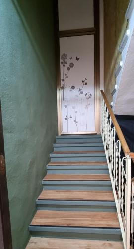 a staircase leading up to a door with a painting on the wall at Quiet Tortellini in Modena