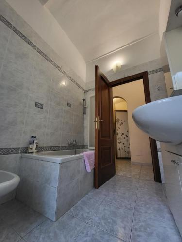 a bathroom with a sink and a bath tub and a sink at Quiet Tortellini in Modena