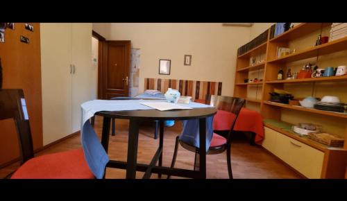 a dining room with a table and chairs and shelves at Quiet Tortellini in Modena