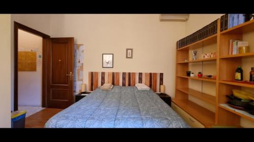 a large bed in a room with wooden shelves at Quiet Tortellini in Modena