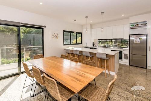 a kitchen with a wooden table and chairs at 1 Anderson Avenue Sandy Point in Sandy Point