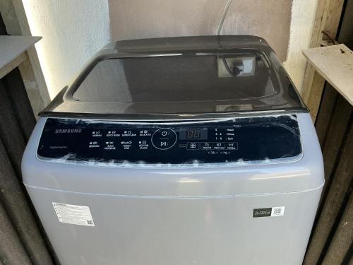 a washing machine is sitting in a room at BambooBeachVilla1 AC New OCEANFRONT POOL sunsetview garden kitchen SATELLITE STARLINK WI-FI in Dimiao