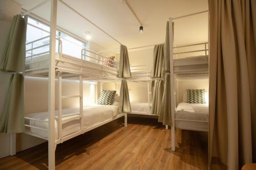 two bunk beds in a room with a window at Little Drifter Glebe in Sydney