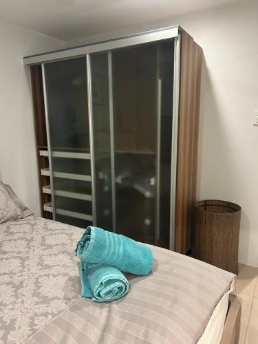 a blue towel sitting on top of a bed at Whitfords Retreat - 2 Bedroom unit in Perth