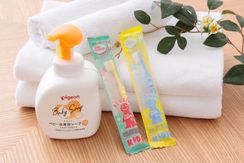 a bottle of baby cleaner next to a pile of towels at 遊び場いっぱい Kidsʻ Play Villa 庭付き貸別荘 最大14名 屋根付きBBQ in Kimitsu