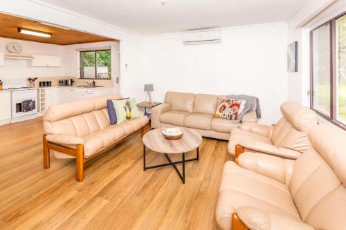 a living room with two couches and a table at At The Point in Sandy Point