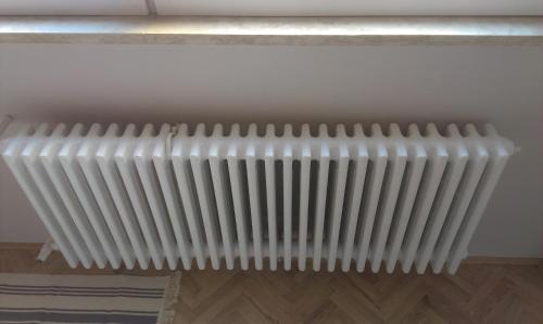 a radiator on the wall of a room at Budanest Apartments in Budapest