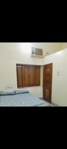 una camera da letto con un letto e un armadio in legno di Gopal Geeta Niwas a Bikaner