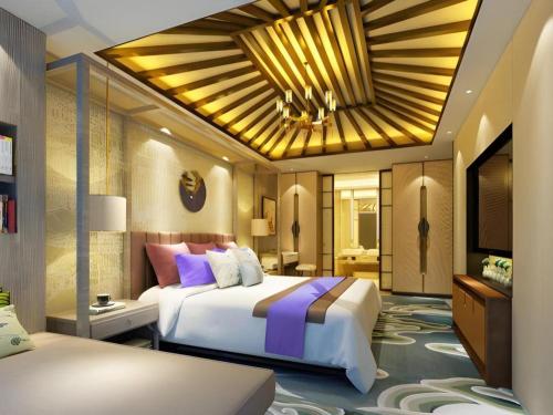 a hotel room with two beds and a television at Yuan Culture Hotel Shenzhen World Shajing in Shenzhen