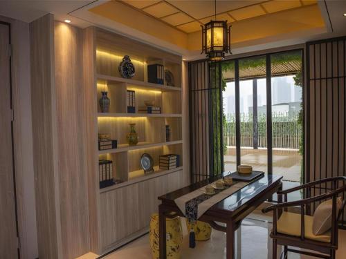 a dining room with a table and a window at Yuan Culture Hotel Shenzhen World Shajing in Shenzhen