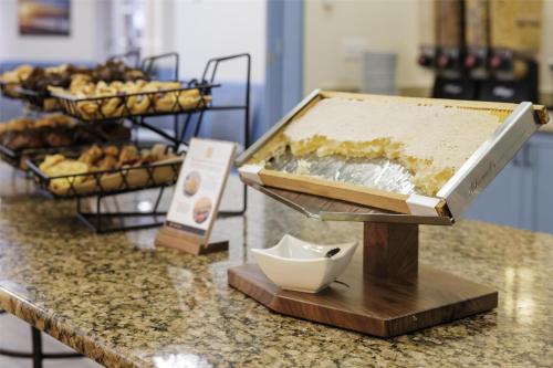 a counter with a tray of bread and pastries at Hilton Myrtle Beach Resort in Myrtle Beach