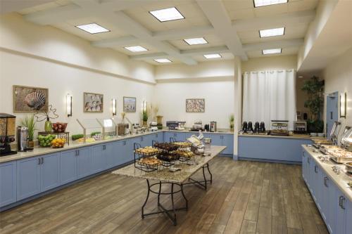 a large kitchen with blue cabinets and a table at Hilton Myrtle Beach Resort in Myrtle Beach