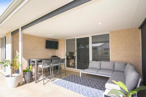 a living room with a couch and a table at Jetty Retreat- minutes to town and beach in Busselton