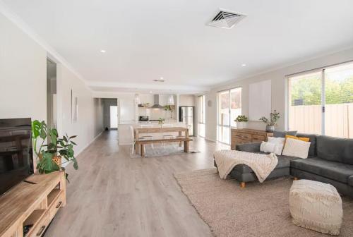 a living room with a couch and a table at Jetty Retreat- minutes to town and beach in Busselton