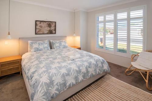 a bedroom with a bed with a stuffed animal on it at Jetty Retreat- minutes to town and beach in Busselton
