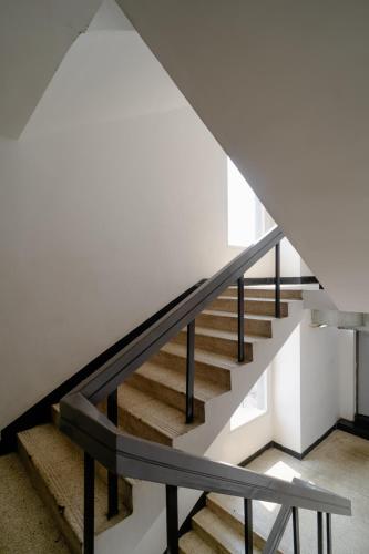 a staircase in a house with a metal railing at Hotel Asrani International in Secunderabad