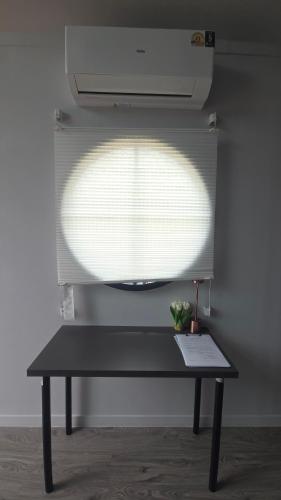 a window with a black bench in a room at Grace Riverfront in Lat Krabang
