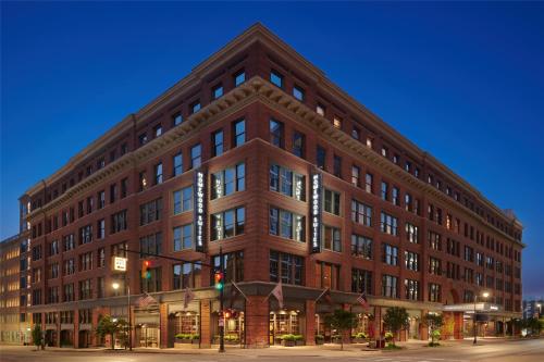 a large brick building on the corner of a street at Homewood Suites by Hilton Grand Rapids Downtown in Grand Rapids