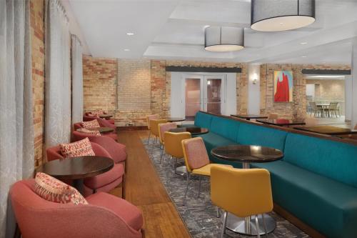 a restaurant with tables and chairs and a bar at Homewood Suites by Hilton Grand Rapids Downtown in Grand Rapids