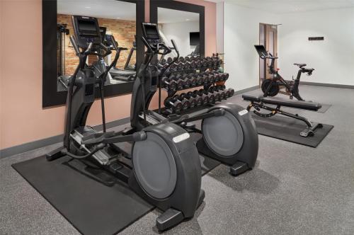 a gym with a row of treadmills and ellipticals at Homewood Suites by Hilton Grand Rapids Downtown in Grand Rapids