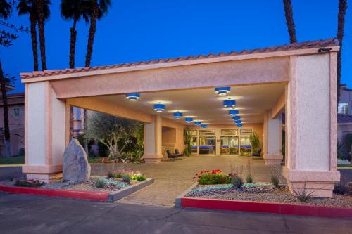 an empty lobby of a hotel with palm trees at Hyatt Vacation Club at Desert Oasis in Cathedral City