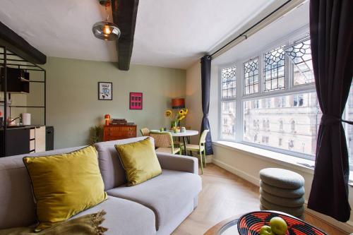 a living room with a couch and a large window at Curated 1BR Apartment with City Views & Central! in Chester