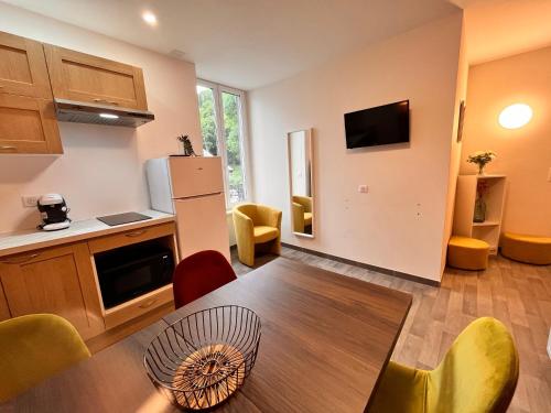 une cuisine et une salle à manger avec une table et des chaises dans l'établissement Villa Le Régis, des moments simples et vrais, à Le Mont-Dore