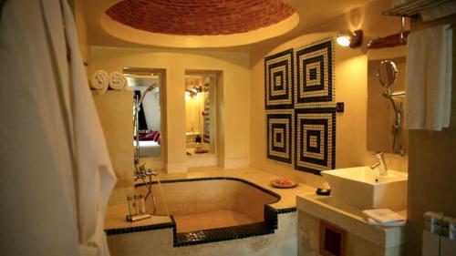a bathroom with a tub and a sink at Domaine Malika - Adults Only in Ouirgane