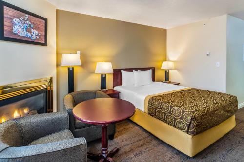 a hotel room with a bed and a fireplace at Econo Lodge Inn & Suites High Level in High Level