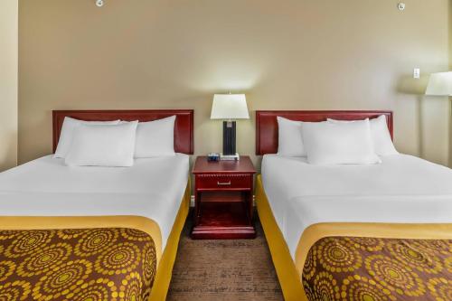two beds sitting next to each other in a room at Econo Lodge Inn & Suites High Level in High Level