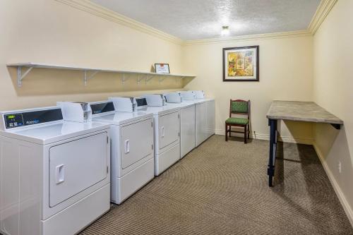 a row of washers and dryers in a laundry room at Econo Lodge Inn & Suites High Level in High Level