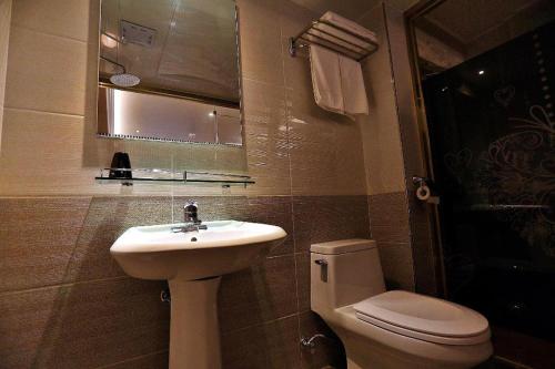 a bathroom with a sink and a toilet at Jeju Sejong Hotel in Jeju