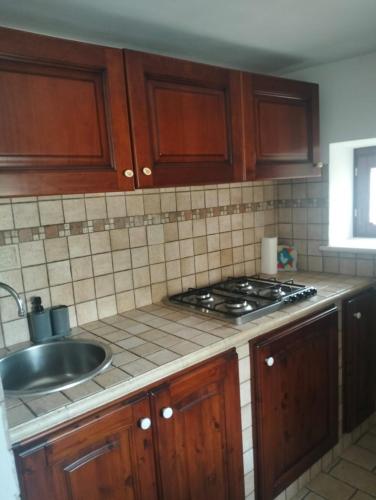 a kitchen with a sink and a stove top oven at il cortile in Calascio