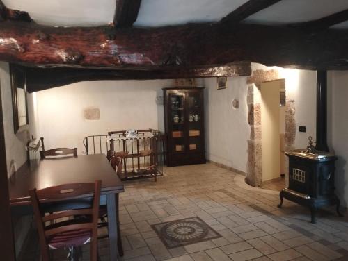 a living room with a table and a wood stove at il cortile in Calascio