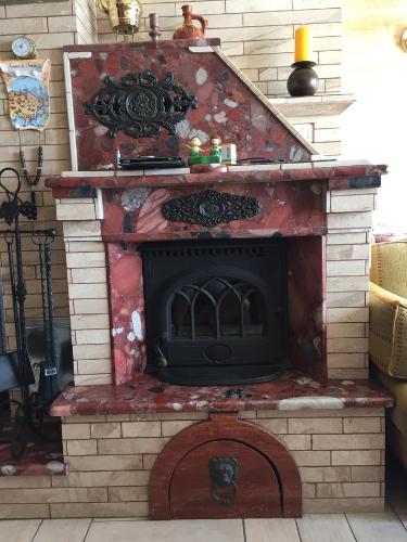 a brick fireplace with an open door in a house at Villa Edelweiss in Sveti Stefan