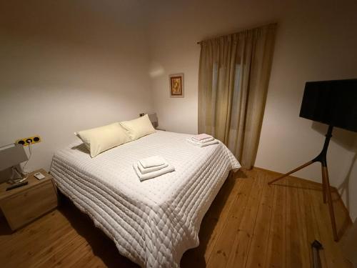 a bedroom with a bed with two towels on it at Villa GIANNAKOS MINOAN HERSONISSOS in Kastéllion