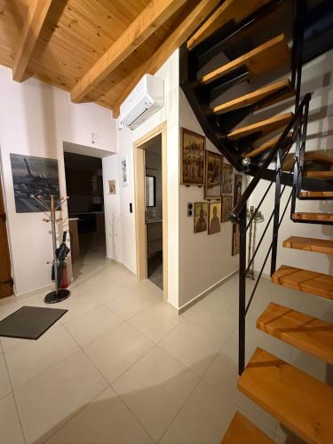 a living room with a staircase in a house at Villa GIANNAKOS MINOAN HERSONISSOS in Kastéllion