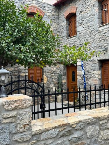 a black fence in front of a stone building at Villa GIANNAKOS MINOAN HERSONISSOS in Kastéllion