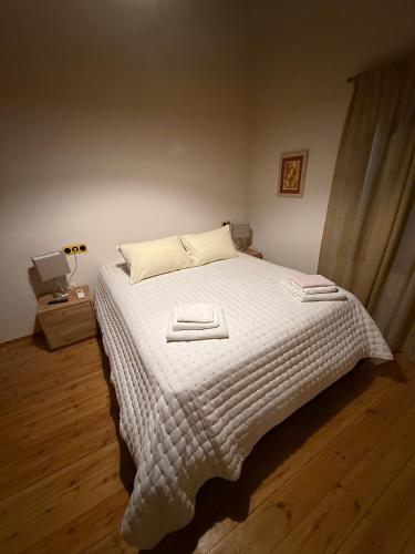 a bedroom with a bed with a white comforter at Villa GIANNAKOS MINOAN HERSONISSOS in Kastéllion