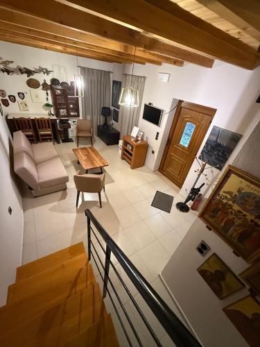 a living room with a couch and a table at Villa GIANNAKOS MINOAN HERSONISSOS in Kastéllion