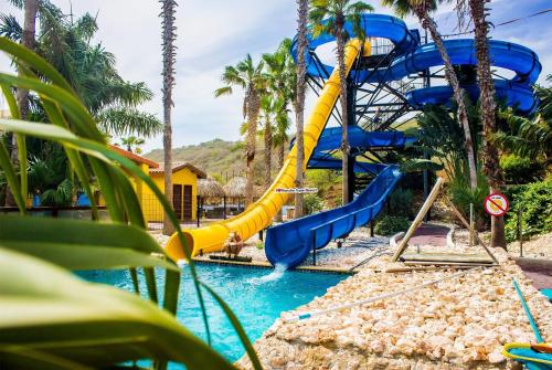 a water slide at a resort with a pool at Kunuku Resort All Inclusive Curacao, Trademark by Wyndham in Willemstad