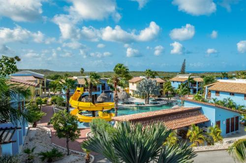 an aerial view of a resort with a water slide at Kunuku Resort All Inclusive Curacao, Trademark by Wyndham in Willemstad