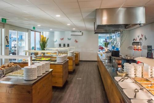 a restaurant with a buffet line of food at Kunuku Resort All Inclusive Curacao, Trademark by Wyndham in Willemstad