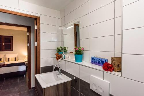 a bathroom with a sink and a mirror at Kunuku Resort All Inclusive Curacao, Trademark by Wyndham in Willemstad