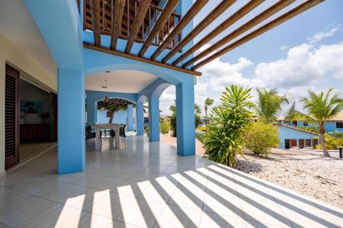 a view of a house with a patio with a table at Kunuku Resort All Inclusive Curacao, Trademark by Wyndham in Willemstad